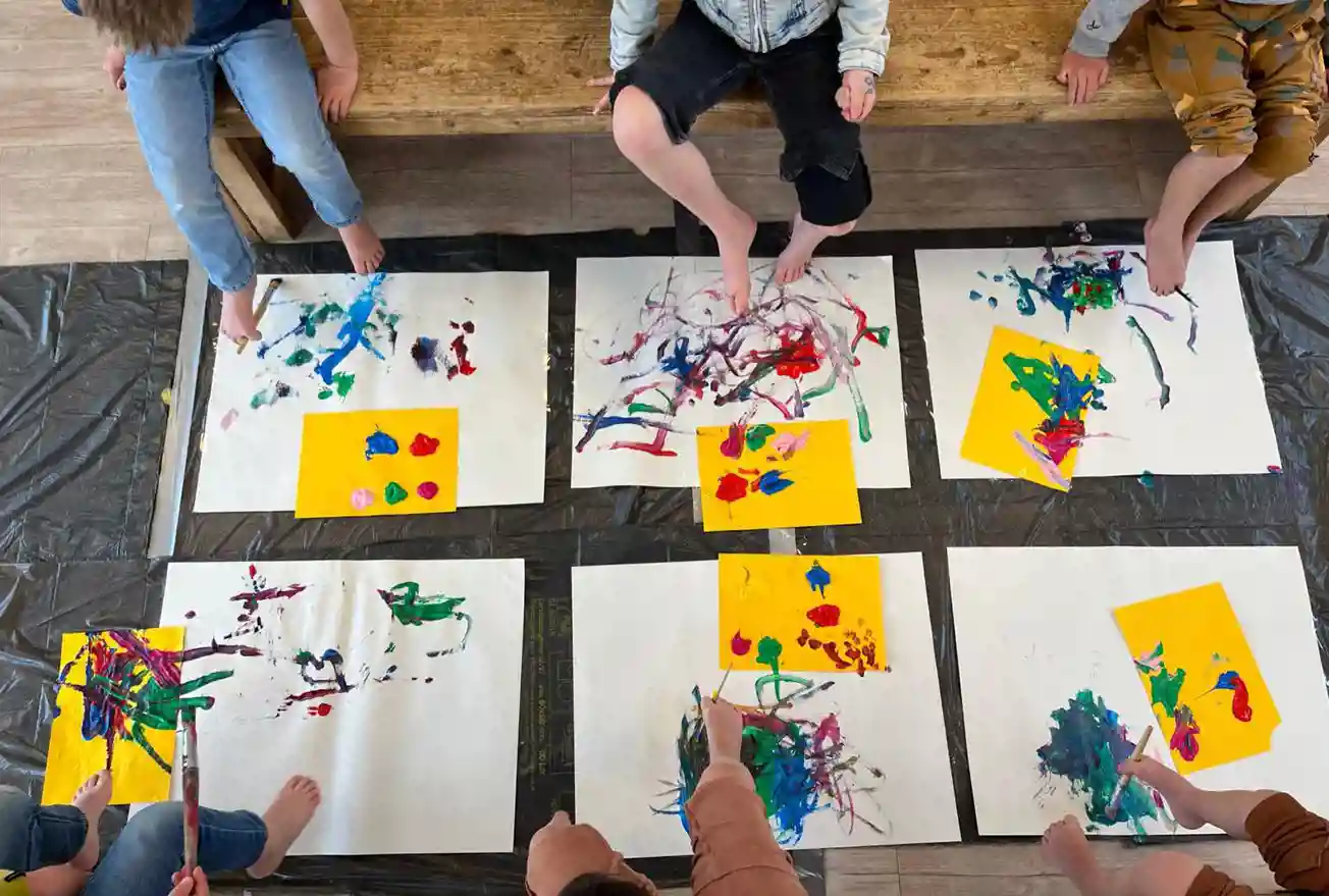 gro-up kinderen schilderen met voeten op de BSO