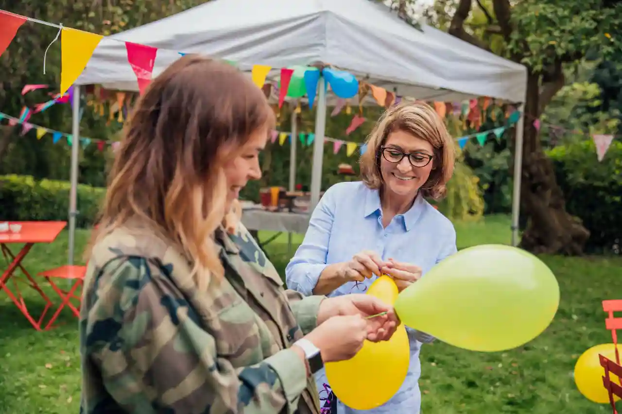 Ondersteuning Bij Bewonersinitiatieven gro-up buurtwerk Twee buurtbewoners blazen ballonnen op voor het door hen met ondersteuning van gro-up buurtwerk georganiseerde bewonerinitiatief