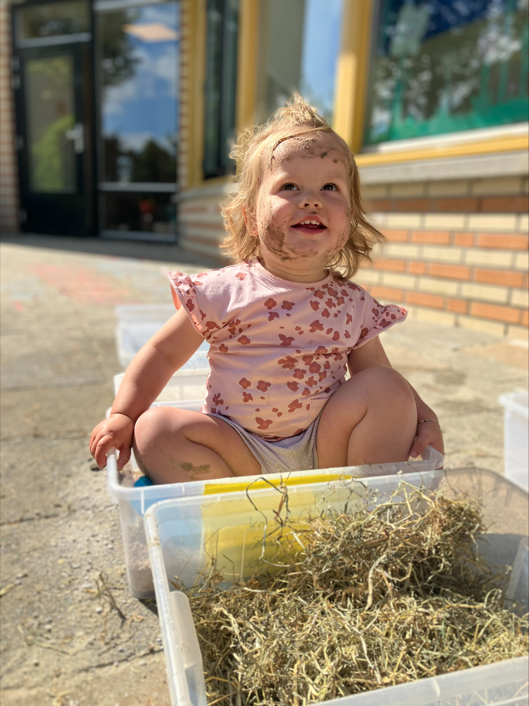 Kind wordt lekker vies tijdens het buitenspelen op peuteropvang De Speeldoos van gro-up